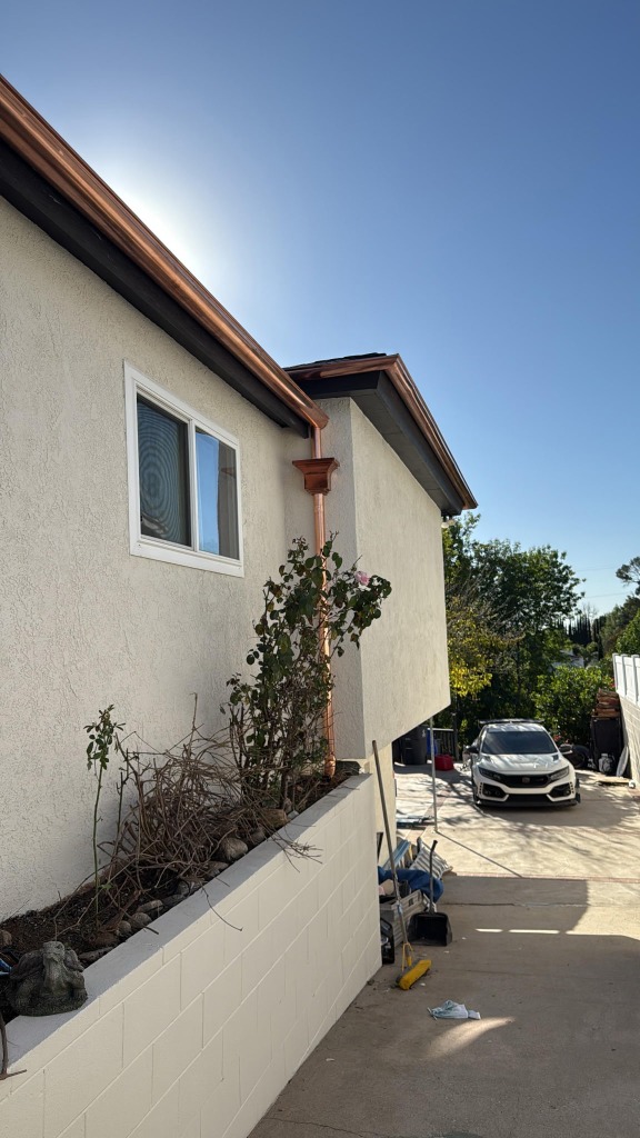 Copper gutter and downspout installation - side view