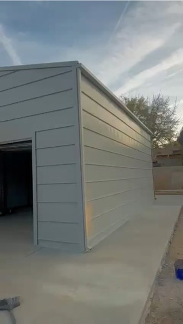 Completed metal building with horizontal lap siding and standing seam roof