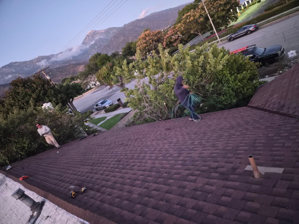 Completed composition shingle roof with mountain backdrop